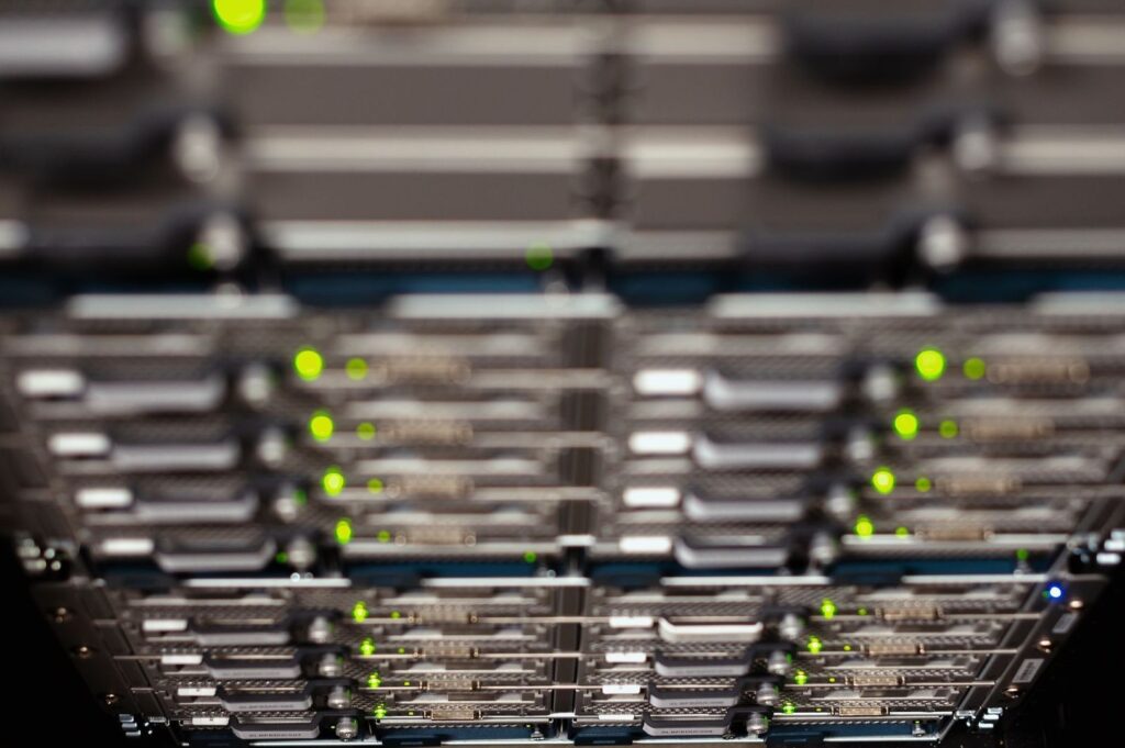 Rows of server equipment with bright green and blue status lights